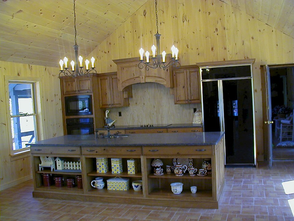 A rustic knotty cherry kitchen with honed ash black granite counter-tops.