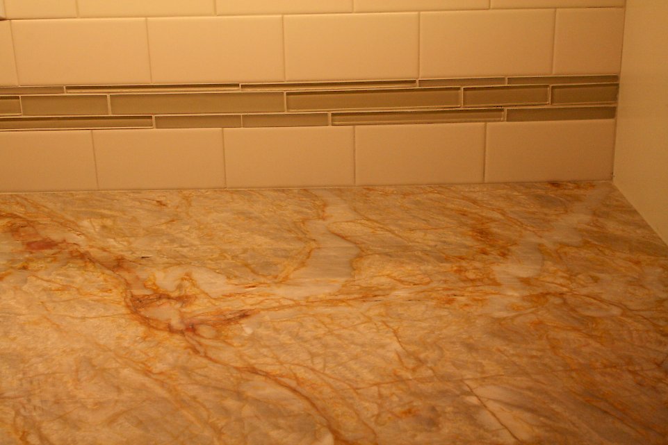 Glass tile accent strips on the backsplash.