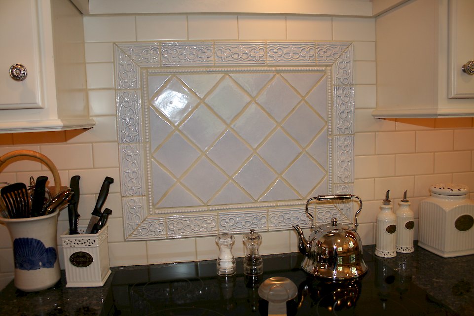 Custom tile backsplash behind the electric range.