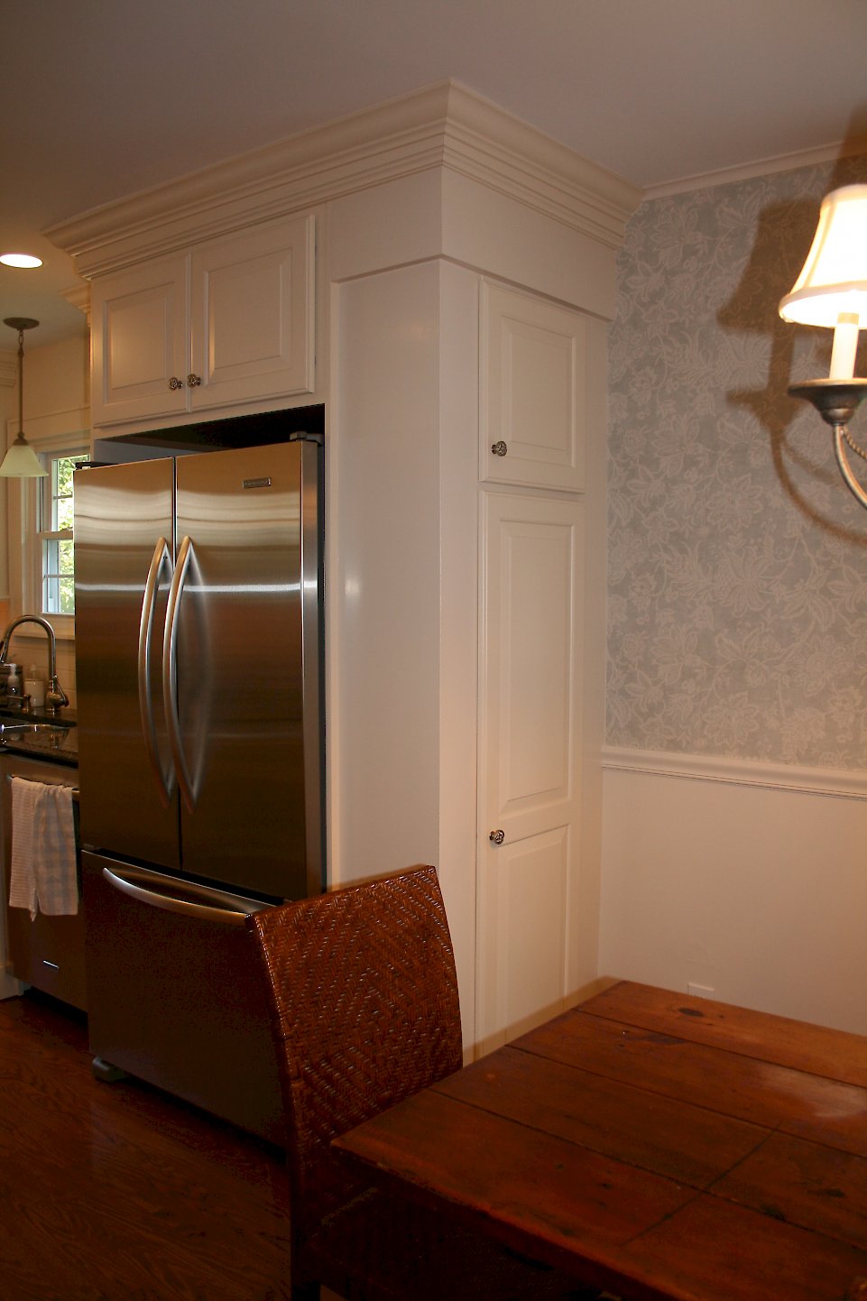 End cabinet next the the refrigerator.