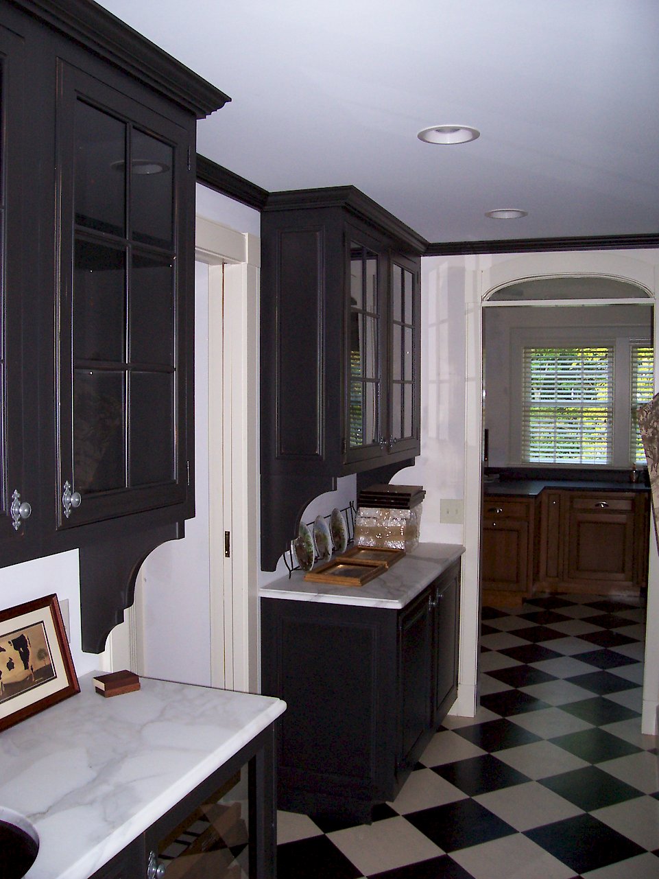 Cottage distressed finish with a brown undercoat on the pantry cabinets.