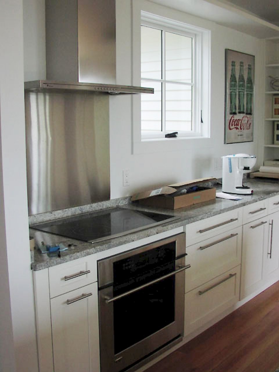 A stainless GE monogram electric cooktop.