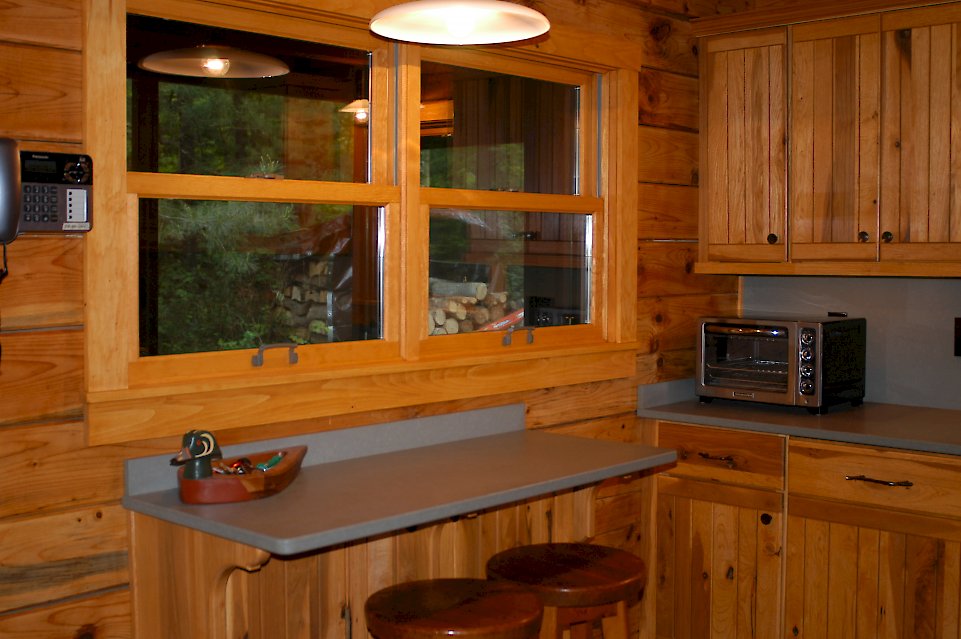 The finish on these cabinets was applied by us to closely match the existing hickory walls.
