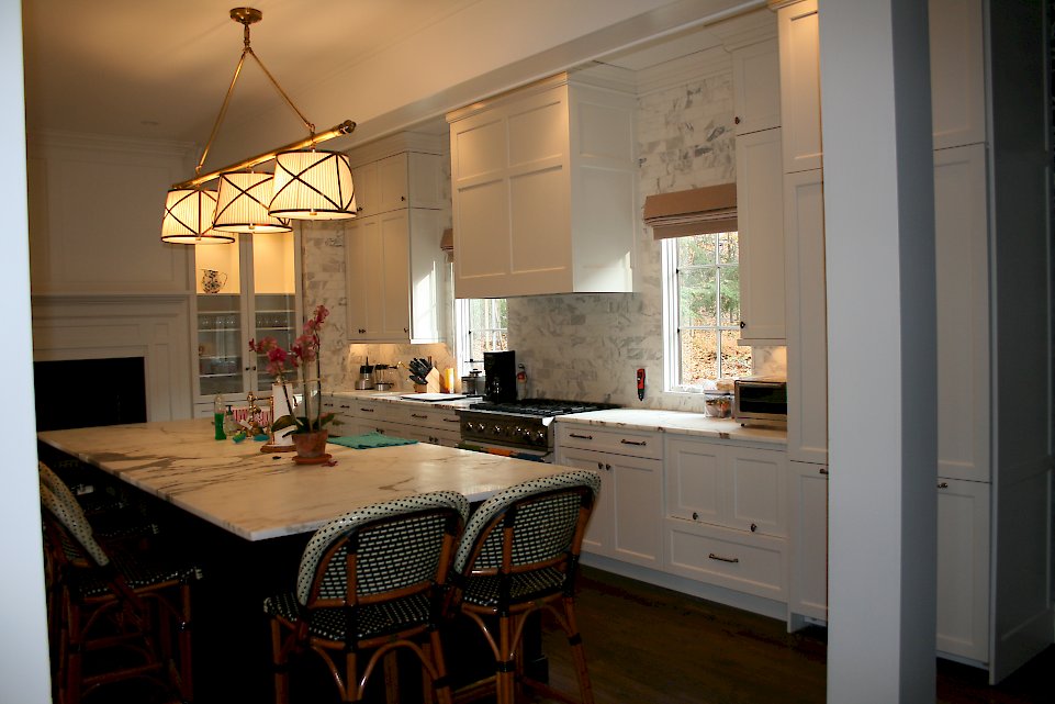 Alpine white maple Kitchen with a large black island.