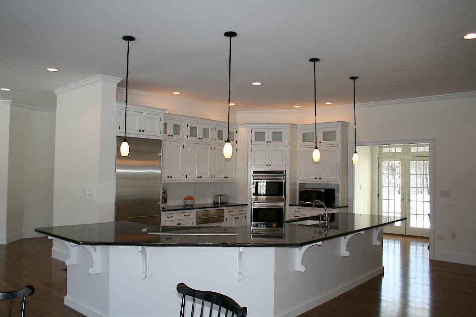 Wood-Mode inset kitchen Nordic White on Oak wood.