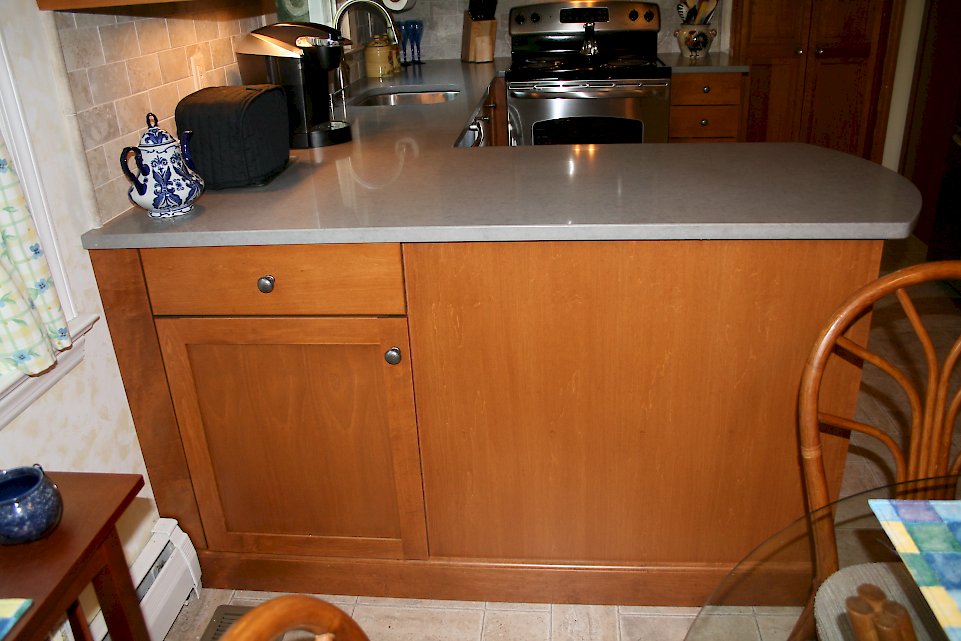 Cabinetry on the outside of the peninsula.