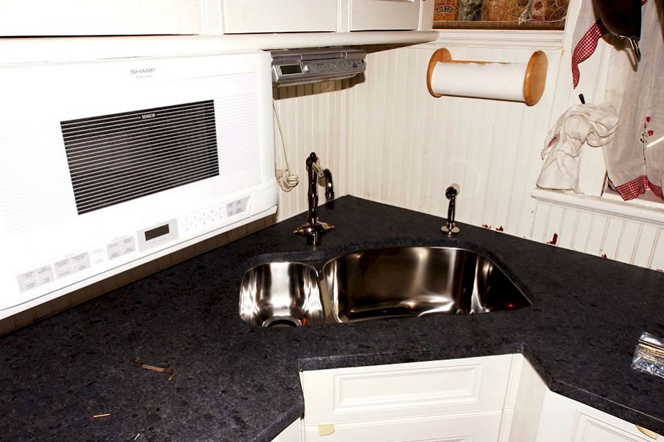 Appoloosa granite counters, with a Blanco stainless sink and Rohl faucet and side spray.