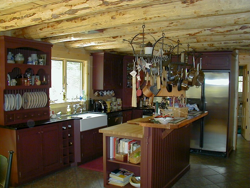 A Wood-Mode kitchen with Sturbridge Inset Recessed door style and Absolute black counters.