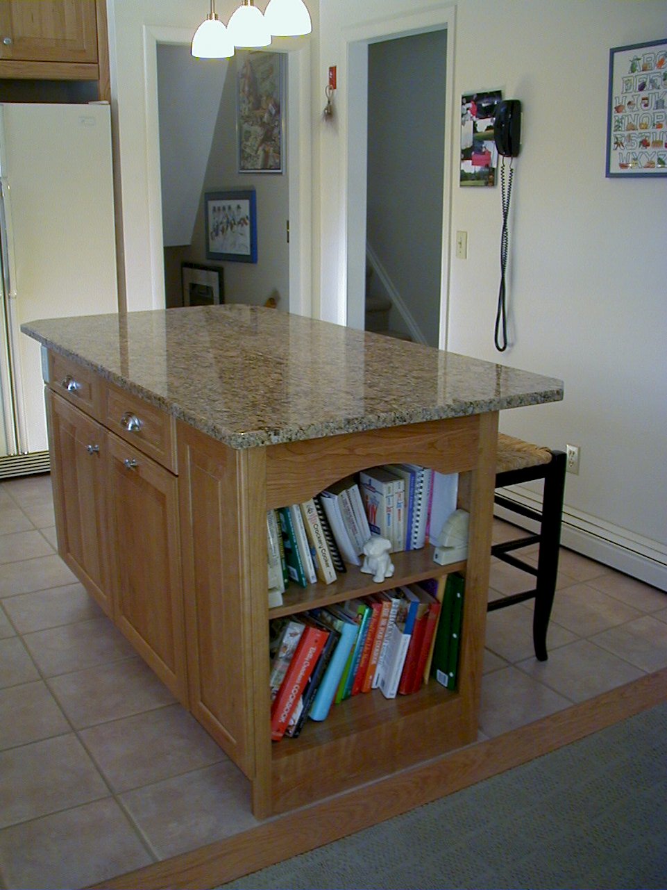 Open shelving on the end of the island for extra storage.