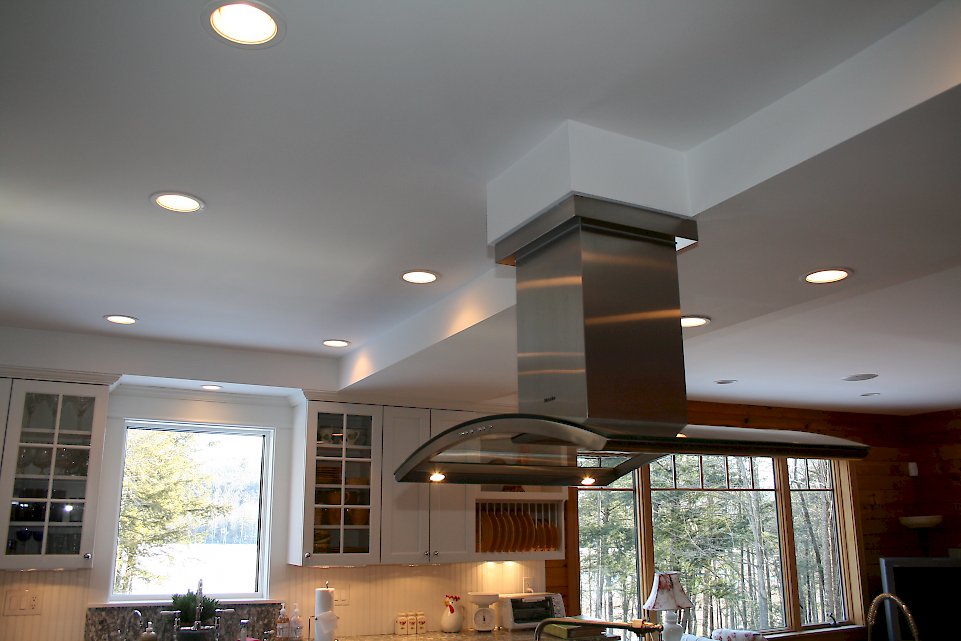Stainless steel chimney hood above the rangetop.