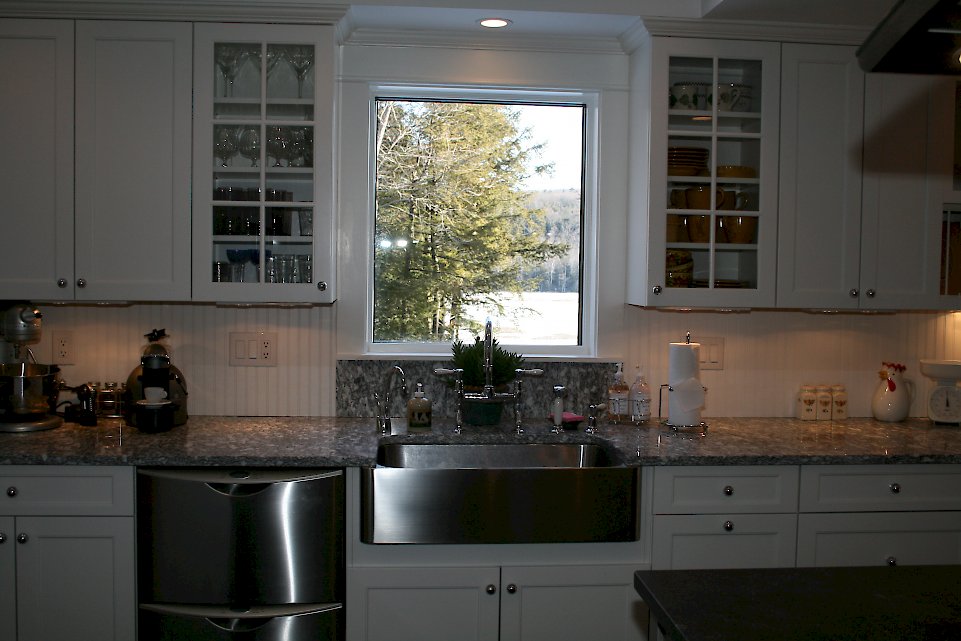 A stainless steel apron front sink and Serizzo Montelosa counters.