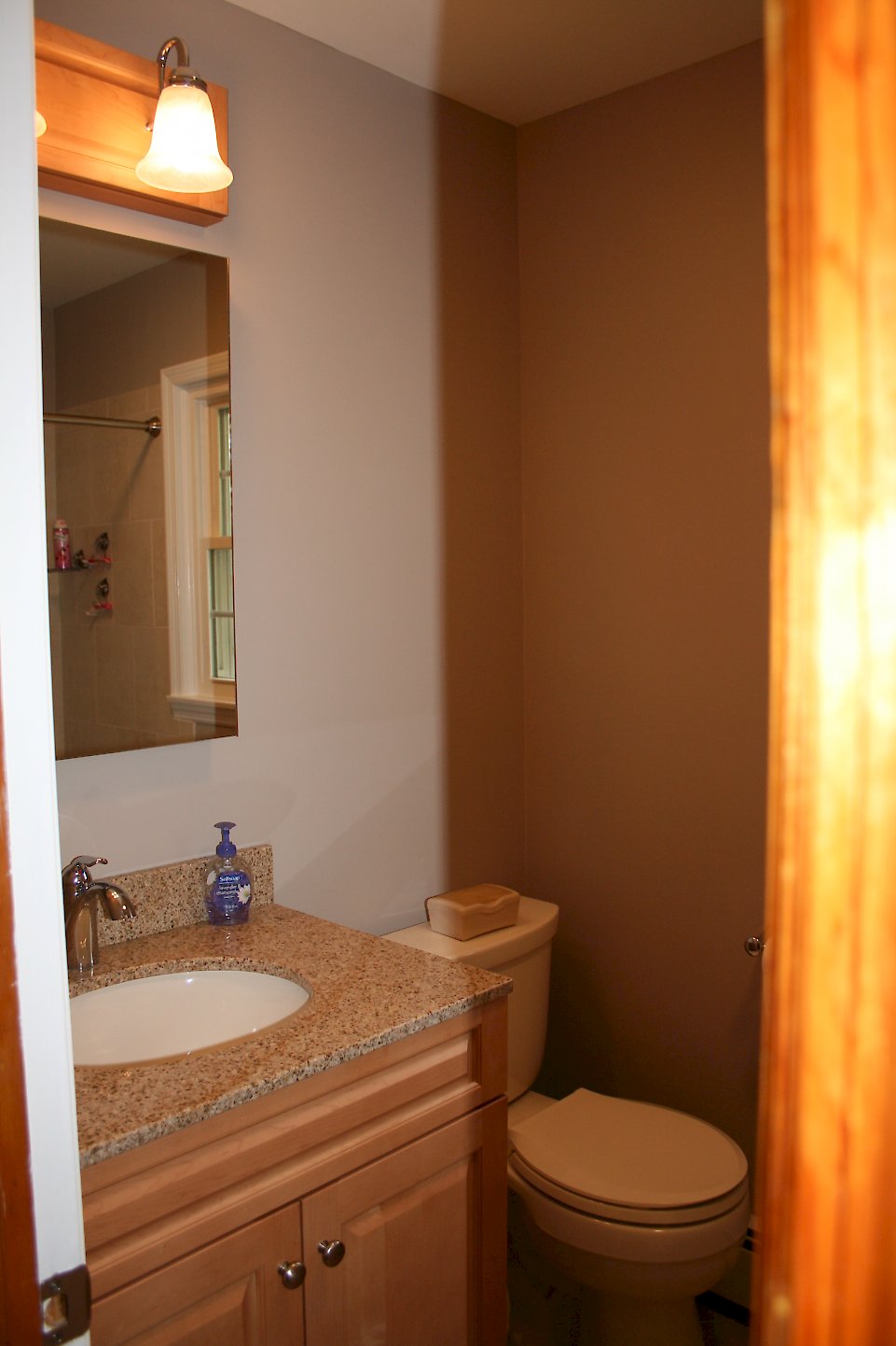 Kohler Cimarron biscuit toilet in the corner.