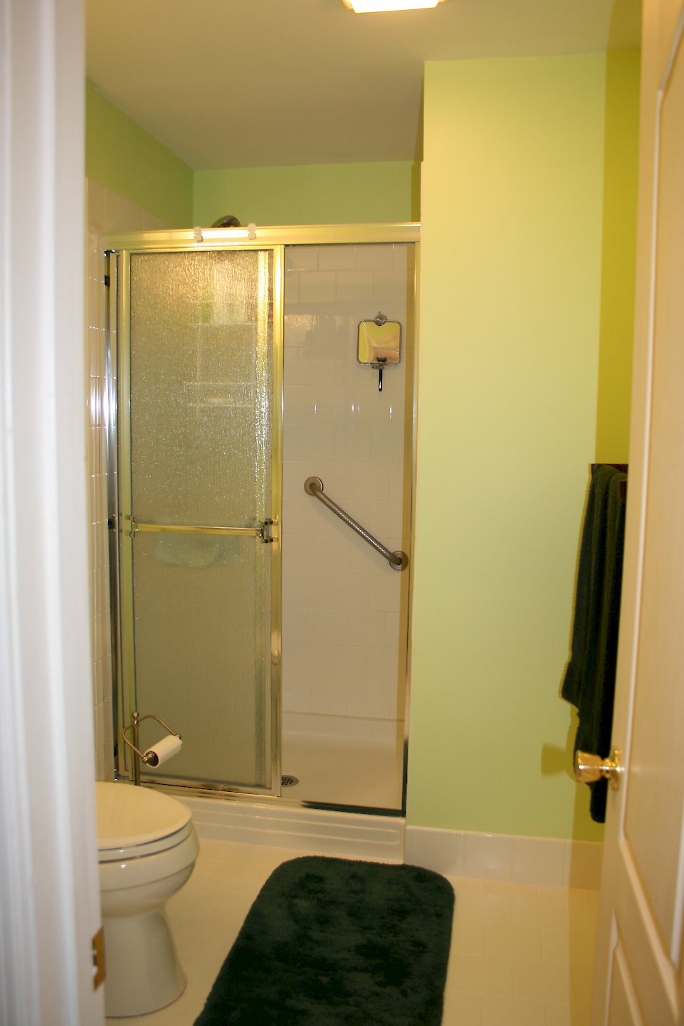 Gold framed shower doors with rain glass.