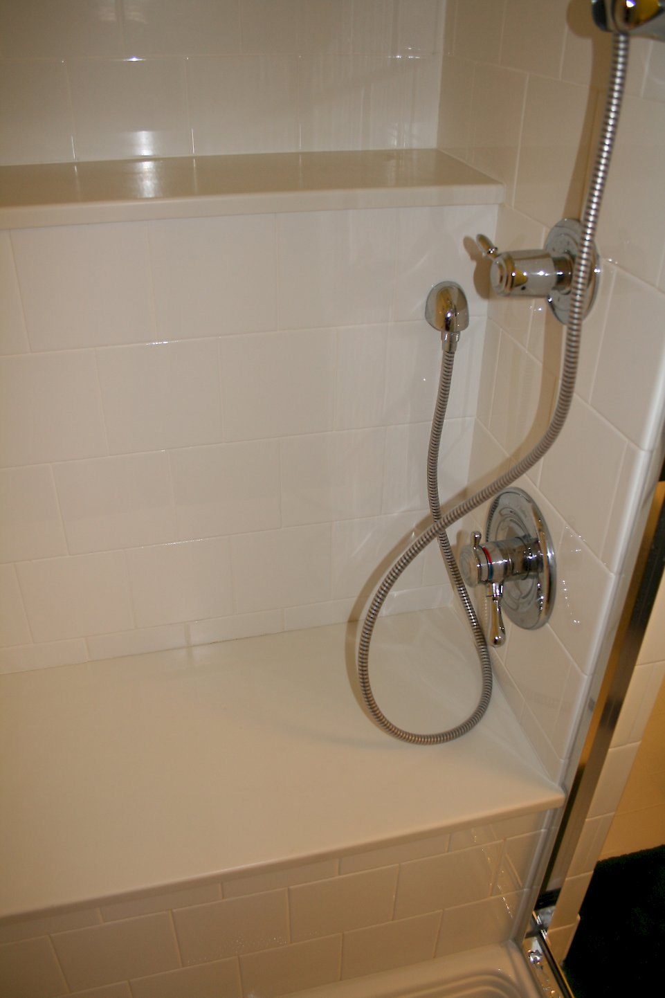 Corian shower seat and shelf.