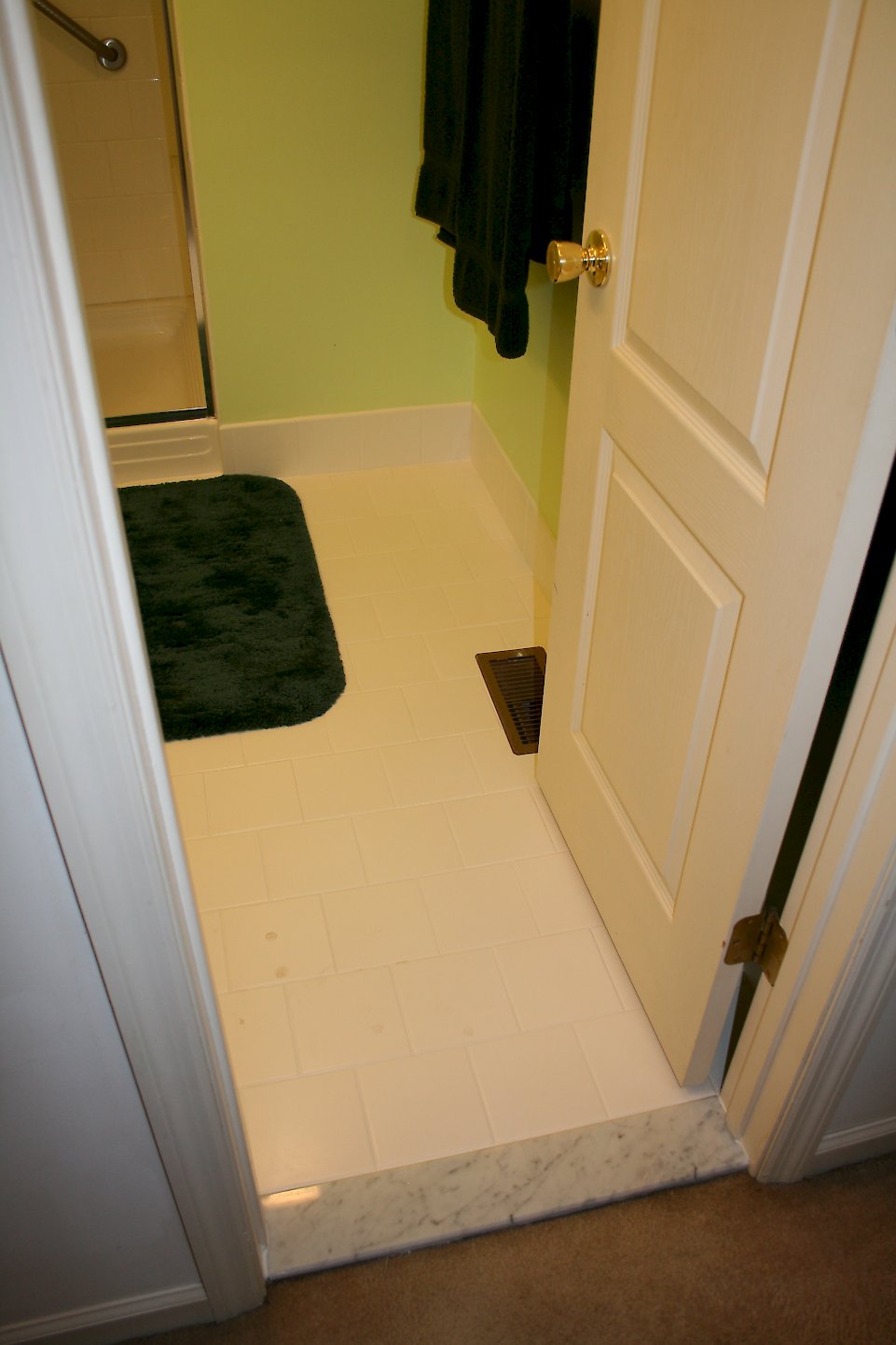 Marble threshold entering the bathroom.